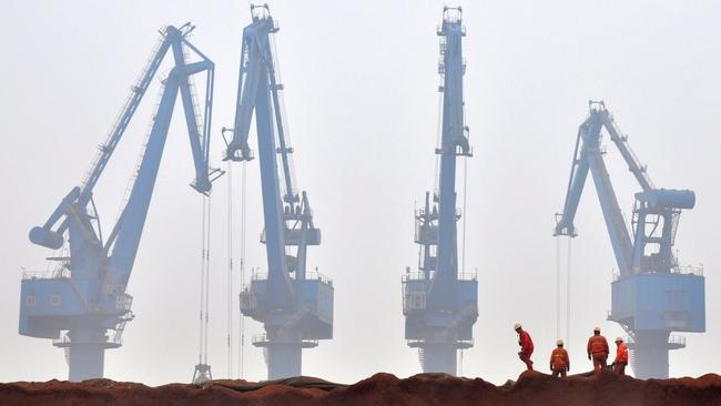 Iron ore being unloaded at a port in China. Picture: Reuters