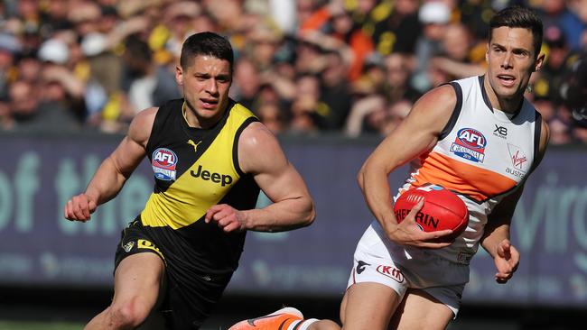 Josh Kelly with the ball and Dion Prestia in hot pursuit. Picture: Michael Klein.