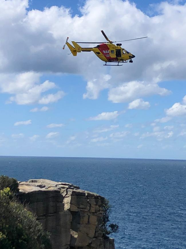 A helicopter flies over the scene of the tragic fall.