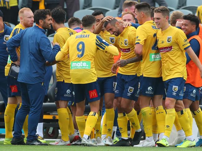 Duric is surrounded by teammates after his goal.