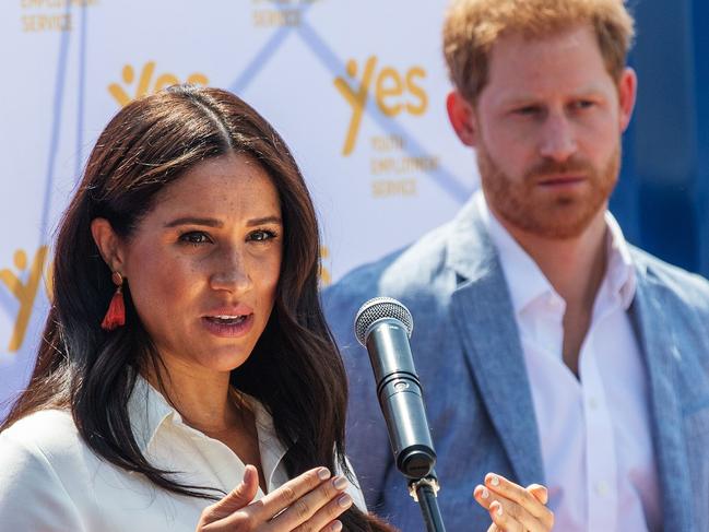 (FILES) In this file photo taken on October 2, 2019, Meghan Markle, Duchess of Sussex(L), is watched by Britain's Prince Harry, Duke of Sussex as she speaks at the Youth Employment Services Hub in Tembisa township, Johannesburg. - Markle paid tribute to George Floyd on June 4, 2020, as protests over his death in police custody sweep the nation, and expressed support for the Black Lives Matter movement. "I realized the only wrong thing to say is to say nothing because George Floydâs life mattered," Markle, who is biracial, said in a videotaped message to new graduates from her alma mater in Los Angeles, Immaculate Heart High School. (Photo by Michele Spatari / AFP)