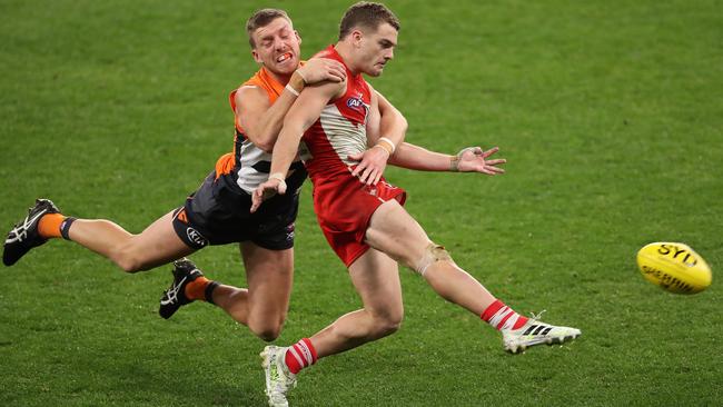 Tom Papley of the Swans gets his kick away while being tackled by Aidan Corr of the Giants at Optus Stadium. Picture: Getty Images