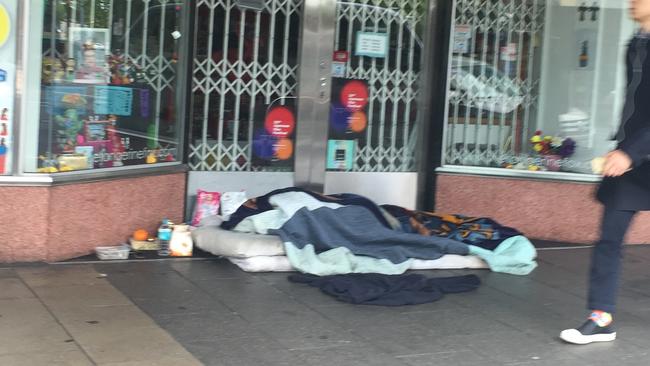 Someone sleeping rough outside a business in the CBD.