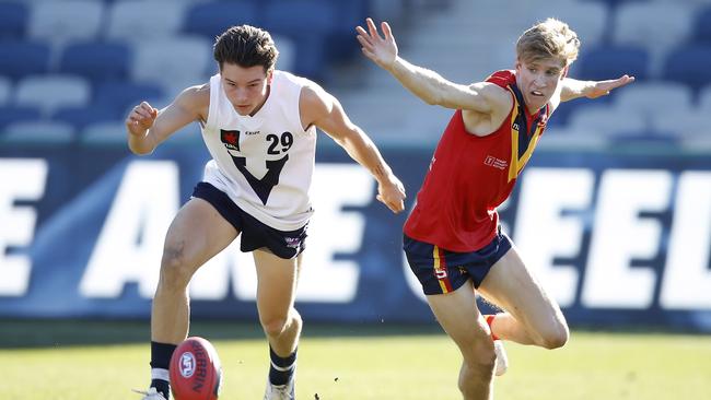 Lachlan Williams of Vic Country beats South Australia’s Dylan Stephens to the loose ball in Geelong. Picture: Dylan Burns/AFL Photos via Getty Images