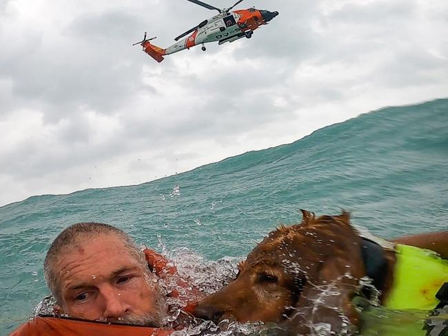 A man and his dog are rescued from off the coast of Florida by the US Coast Guard during Hurricane Helene. Picture: US Coast Guard.