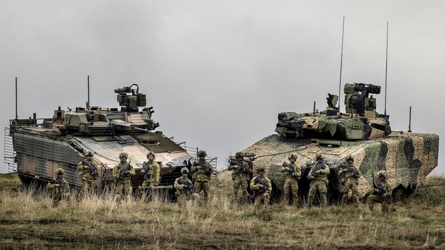 Australian Army soldiers from the 7th Battalion, Royal Australian Regiment, stand with a Hanwha Defence Australia Redback Infantry fighting vehicle (left) and a Rheinmetall Lynx KF4 Infantry Fighting Vehicl at Puckapunyal, Victoria. Picture: ADF.