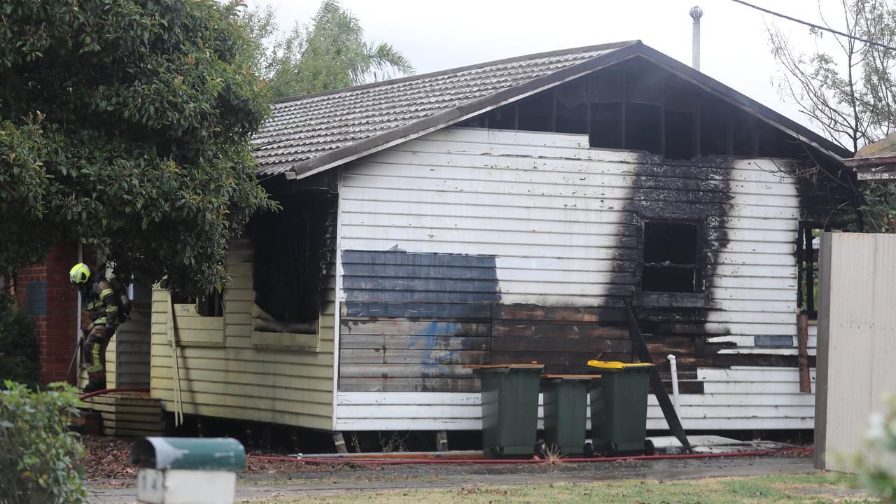 Fire fighters and police on the scene of a house fire on Station Road, North Shore. Picture: Alan Barber