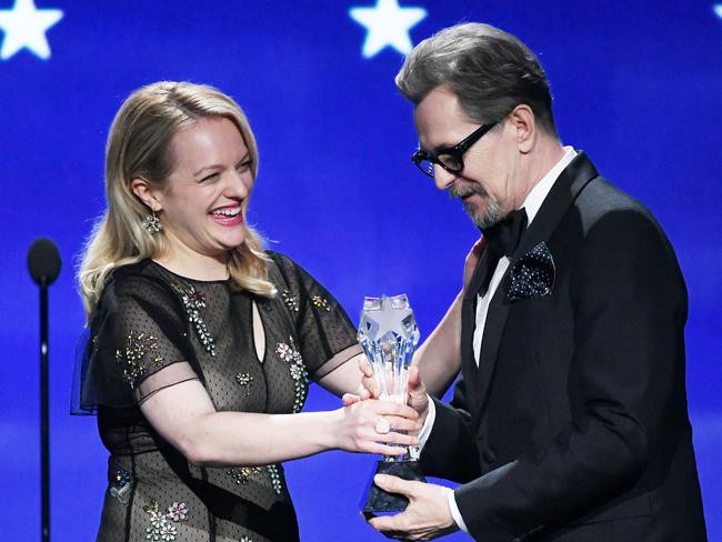 Gary Oldman accepts Best Actor for ‘Darkest Hour’ from actor Elisabeth Moss onstage during The 23rd Annual Critics’ Choice Awards at Barker Hangar on January 11, 2018 in Santa Monica, California. Picture: Getty