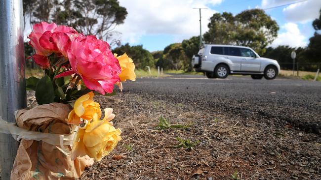 Flowers left at the corner of Smiths Beach Road and Back Beach Road — the scene of a fatal car crash involving a one-year-old. Picture: Hamish Blair.