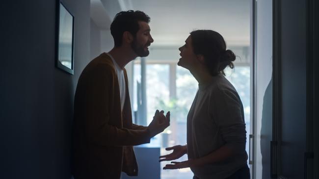 Young Couple Arguing and Fighting. Domestic Violence and Emotional abuse Scene, Stressed Woman and aggressive Man Screaming at Each other in the Dark Hallway of Apartment. Dramatic Scene