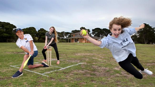 Richard Macafee and daughters Alex, 21, and Eliza, 17, on their backyard cricket pitch. Picture: Glenn Ferguson