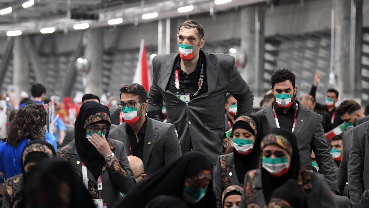 Mehrzad uses crutches as his teammates prepare to walk in the parade of athletes during the opening ceremony of the Tokyo 2020 Paralympic Games. (Photo by Alex Davidson/Getty Images for International Paralympic Committee)