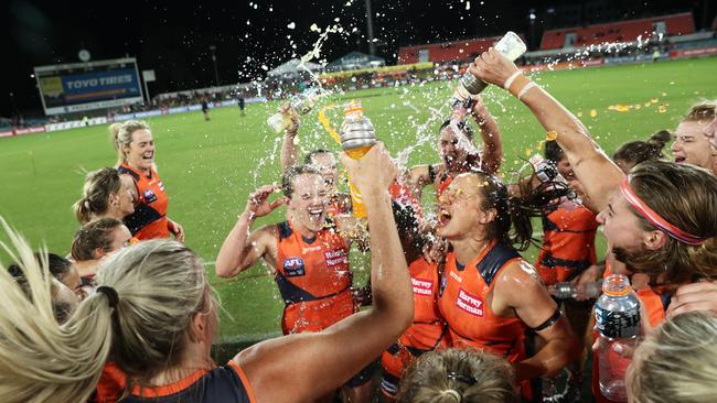 Giants players celebrate victory and sing the club song after belting Geelong in Canberra. Pic: Getty Images