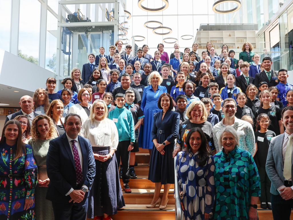 Queen Camilla poses for a group photo with students, authors and representatives from the NSW Government during a visit to the Green Square Library. Picture: Getty