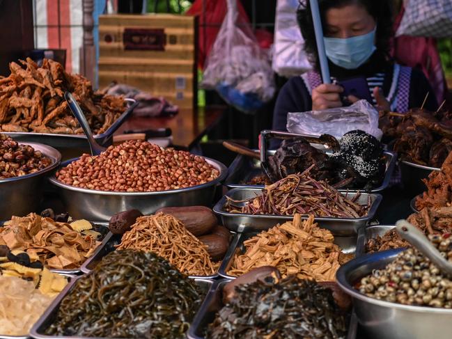 A seller waits for customers at a market in Wuhan. Picture: AFP