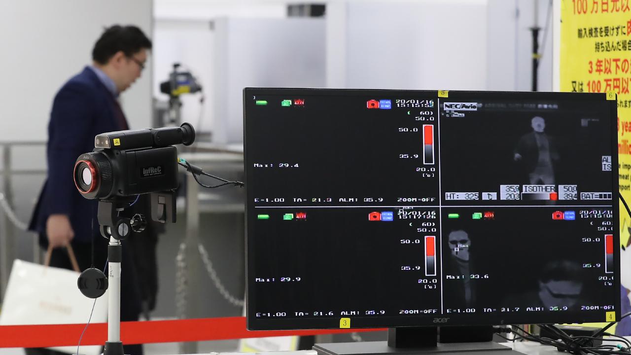 A quarantine station measures body temperatures at Narita Airport in Japan on January 16, 2020. Picture: STR/Jiji Press/AFP