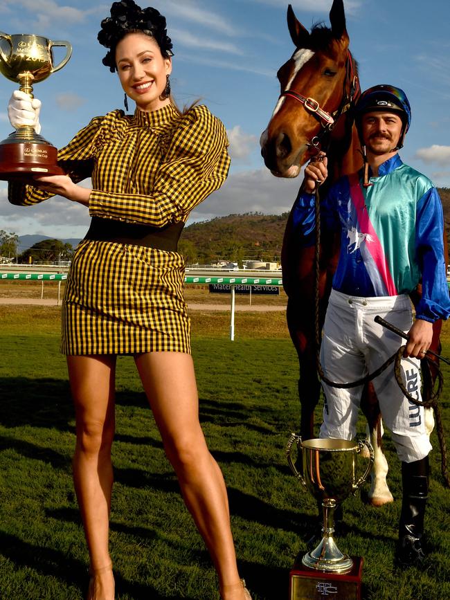 Chantelle O'Neil with the Melbourne Cup, the Townsville Cup, Unbiased and jockey Ashley Butler. Picture: Evan Morgan.