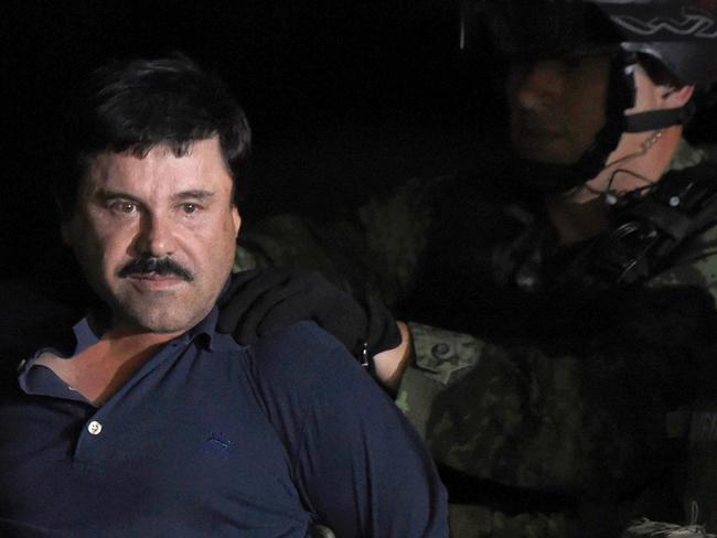 Go directly to jail ... Drug kingpin Joaquin "El Chapo" Guzman is escorted into a helicopter at Mexico City's airport. Picture: AFP