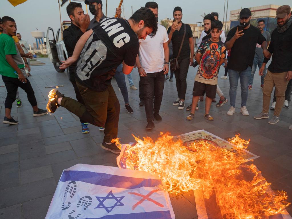 Iraqis burn Israeli flags during a rally held in central Baghdad in support of the Palestinians. Picture: AFP