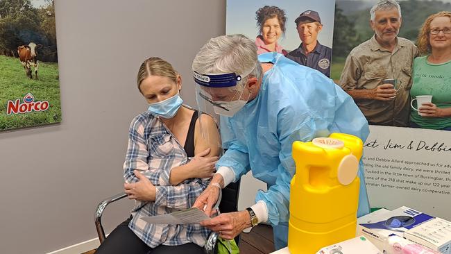 Registered nurse Judy Byrne from First Light Healthcare offers a Covid-19 vaccination to a Norco ice-cream factory worker in Lismore last month.