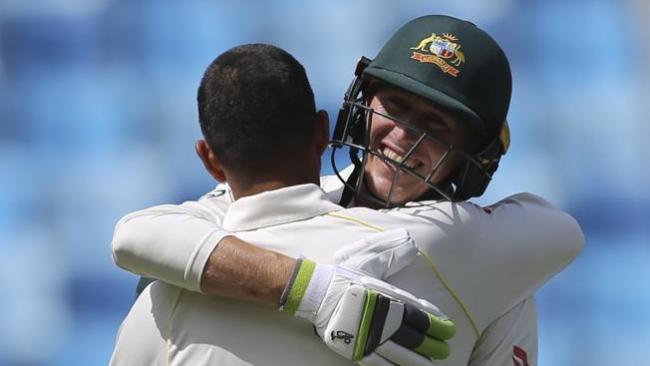 Australian debutant Marnus Labuschagne hugs Usman Khawaja after Khawaja brought up his century.