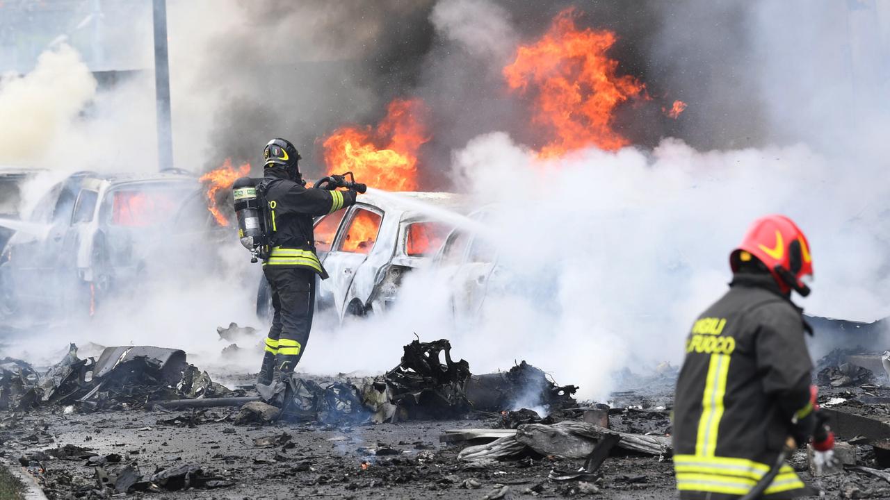 A small private plane crashed into a building in San Donato Milanese district, killing all eight people on board and sparking a massive blaze. Picture: AAP