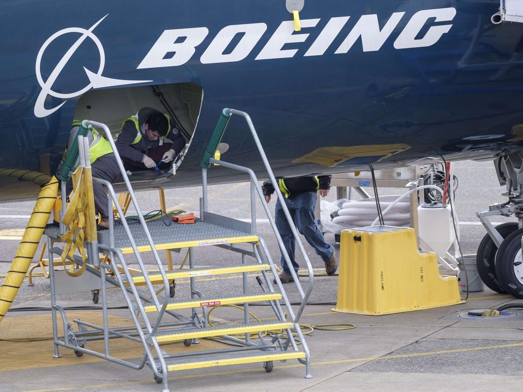 Employees work in the cargo hold of a 727 MAX 9 test plane outside Boeing’s factory in Renton, Washington. Picture: Stephen Brashear/Getty Images/AFP