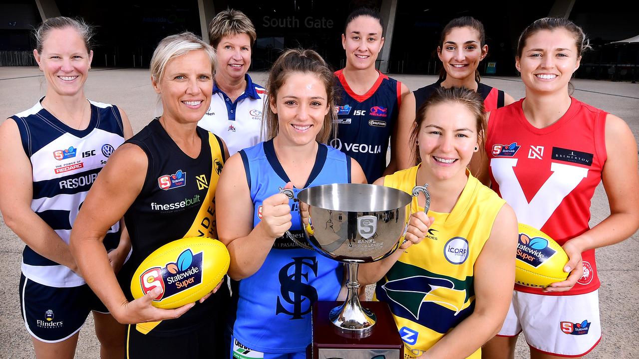 L-R Captains  South Adelaide - Lauren Buchanan ,Glenelg -  Cass Hartley , Centrals Assistant coach Natalie Seaman, Sturt Georgia Bevan, Norwood Leah Cutting,Eagles Adele Gibson, West Adelaide Lauren Rodato and North Adelaide Nadia Von Bertouch pose out the front of Adelaide Oval during the SANFLW launch  today Monday February 11,2019.(Image AAP/Mark Brake)