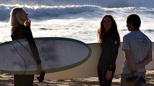 Janine Allis with friends ready to go for a surf.