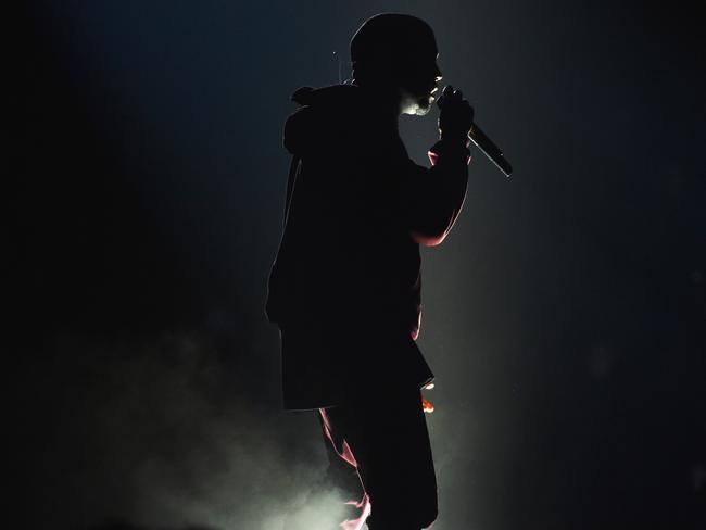 Working the trackie ... Kanye West on stage. Picture: John Shearer/Invision/AP