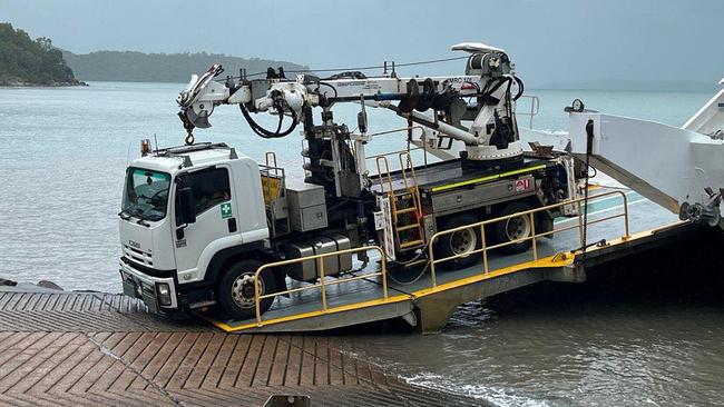 Ergon crews arrive on the barge to Palm Island to restore services after days of intense rainfall and wind. Picture: Palm Island Aboriginal Shire Council.