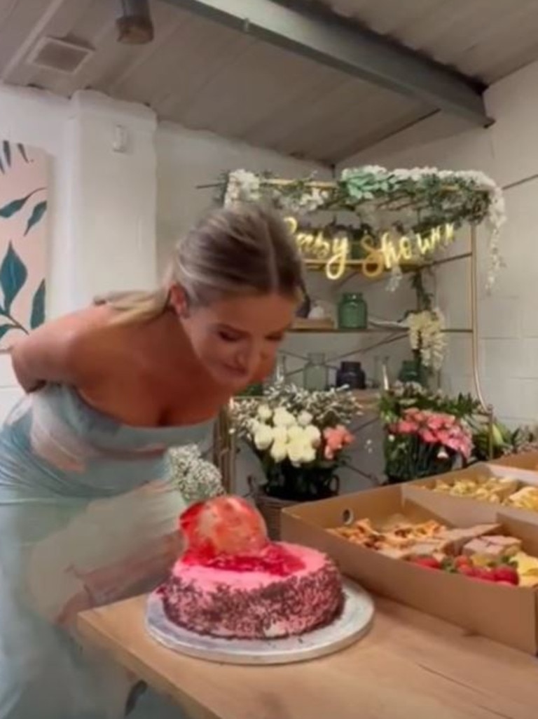 Lucy Graham inspects the dolls head cake decoration. Photo: Instagram, @lcygrhm