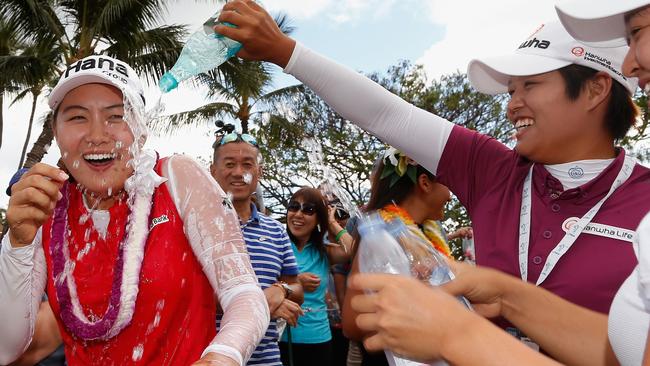 Minjee Lee (L) of Australia has water dumped on her by Haru Nomura of Japan.