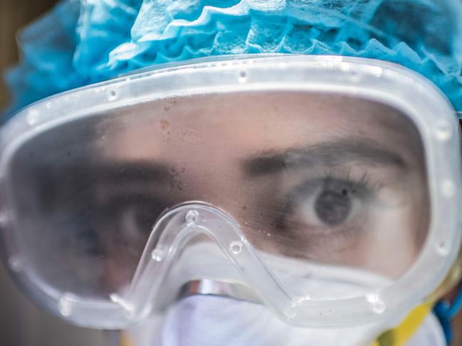 TOPSHOT - A health worker looks on during a door-to-door visit to carry out COVID-19 tests in Mexico City, on June 16, 2020, amid the new coronavirus pandemic. (Photo by PEDRO PARDO / AFP)