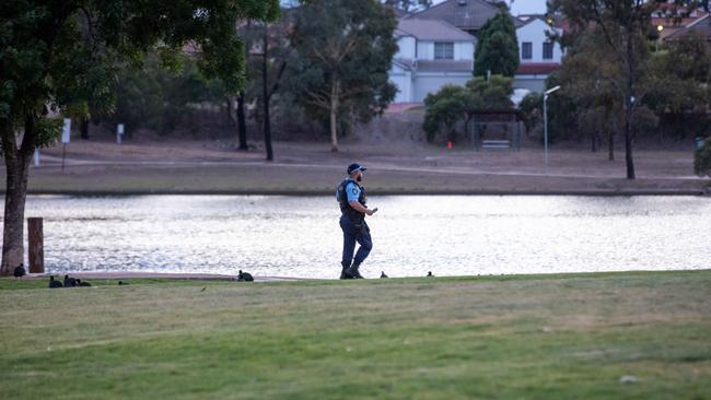 Police at Lake Woodcroft after a group of men stabbed a man as he walked to the gym at 5am on Monday. Picture: Dean Asher