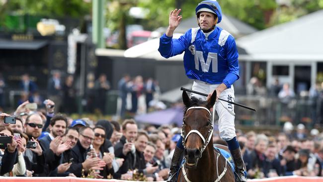 Hugh Bowman celebrates after Winx won the Cox Plate.