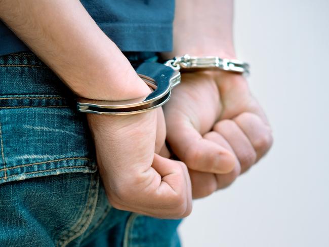 Young man in handcuffs