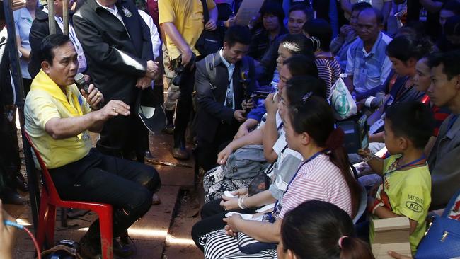 Thailand Prime Minister Prayuth Chan-ocha talks to family members of the 12 boys and their football coach. Picture: AP