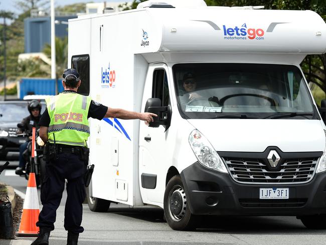 COOLANGATTA, AUSTRALIA - JULY 10: Police are seen directing Victorian licence plate drivers into the side street at the Griffith Street checkpoint at Coolangatta on July 10, 2020 in Coolangatta, Australia. Queensland's borders will reopen to interstate travellers from midday on Friday, with the exception of visitors from Victoria. Anyone entering Queensland will need to have a Queensland Border Declaration Pass and must prove they have not been in Victoria over the past 14 days. Queensland residents returning to the state who have been in Victoria will be required to hotel quarantine, at their own expense. (Photo by Matt Roberts/Getty Images)