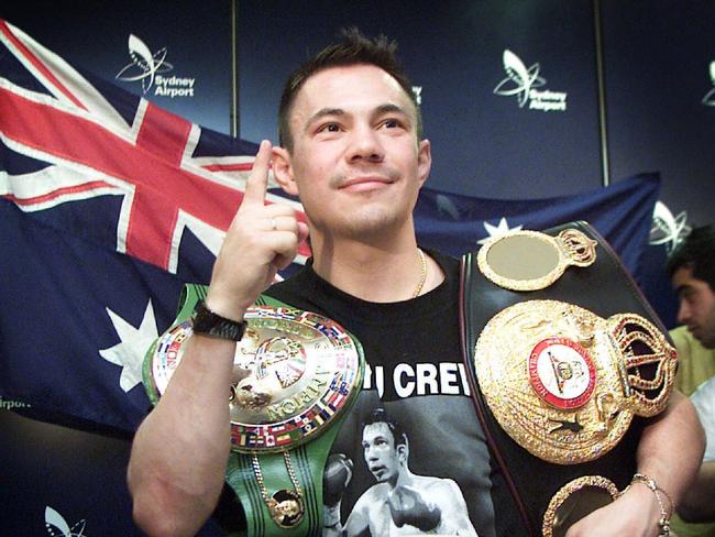 Kostya Tszyu with the belts which made him undisputed champion.