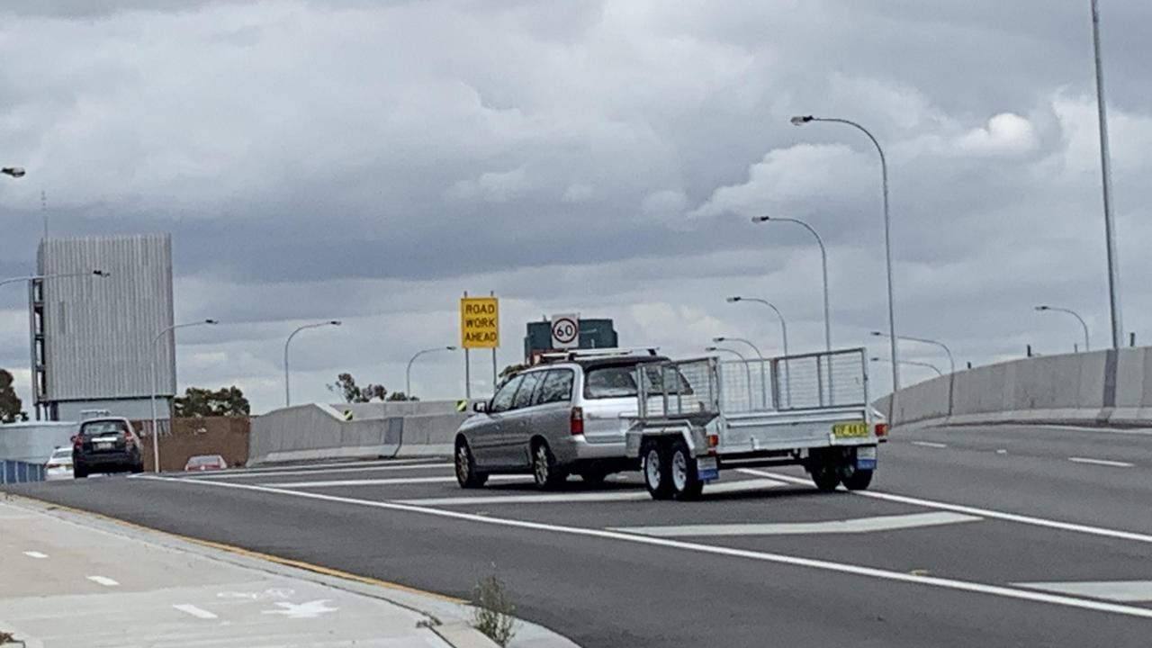 A vehicle with a trailer swaps lanes just before the road physically splits in two. Picture: Benedict Brook