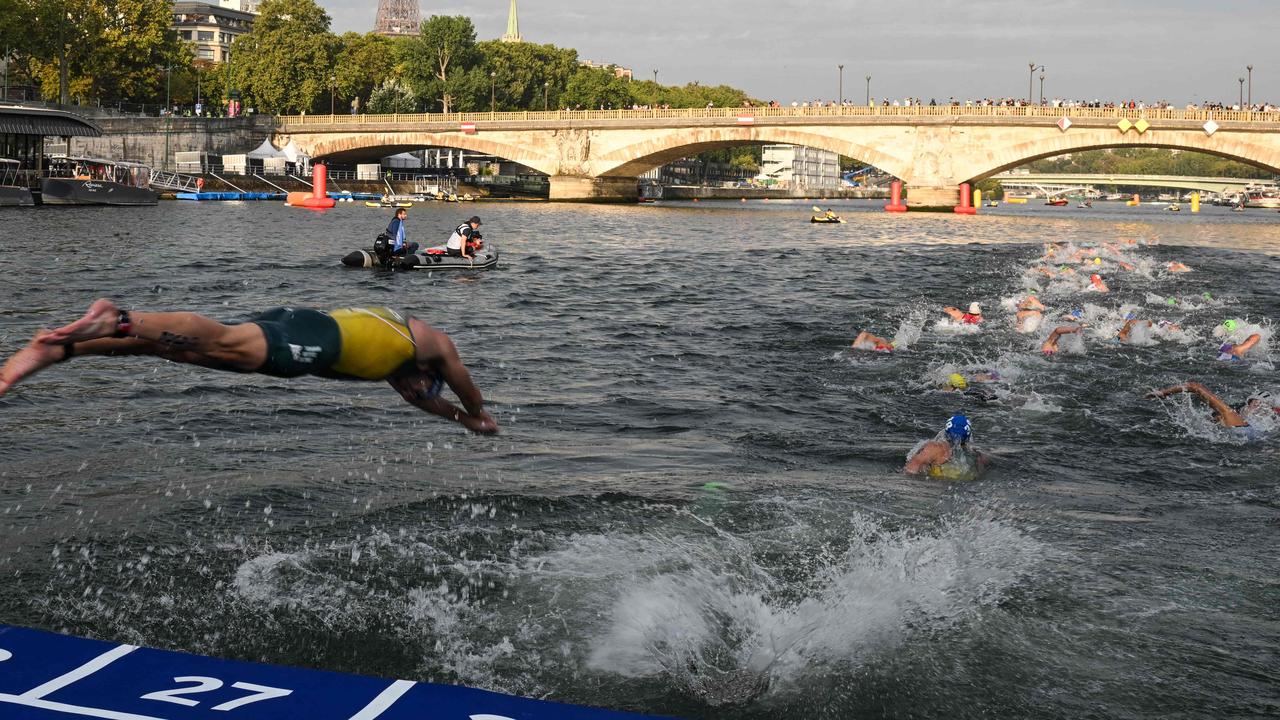 A triathlete dives in the Seine River at the 2023 World Triathlon event last year. Photo by Bertrand GUAY / AFP