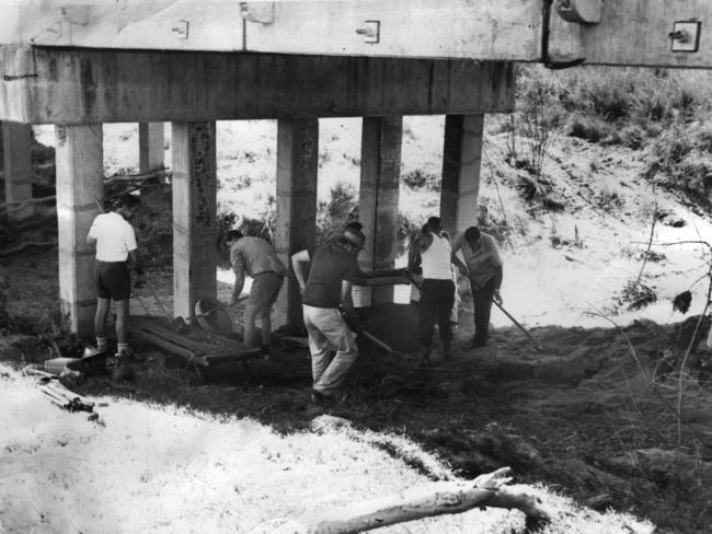 File Photo from November 18, 1972: Police digging and sifting soil under the Sensible creek railway bridge west of Charters Towers where a skeleton was found.