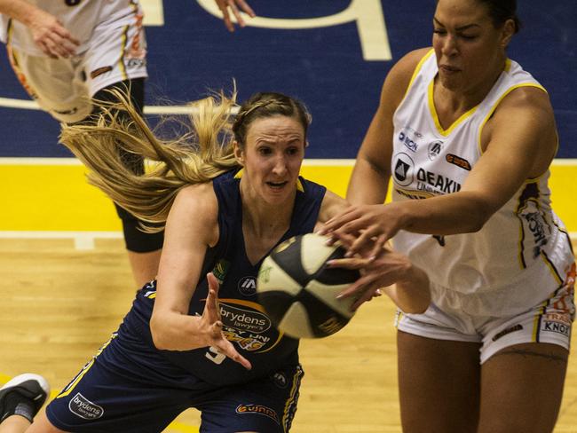 Flames’ Jennifer Hamson (left) and Boomers’ Liz Cambage compete for the ball on Friday night.