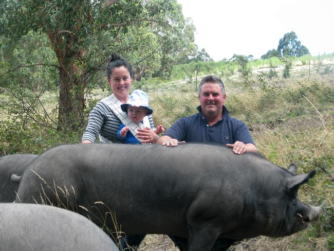 Pig producers Damien and Lillian Reardon with baby Gideon and their Berkshire boar Mr Rochester. Picture: ELAINE REEVES