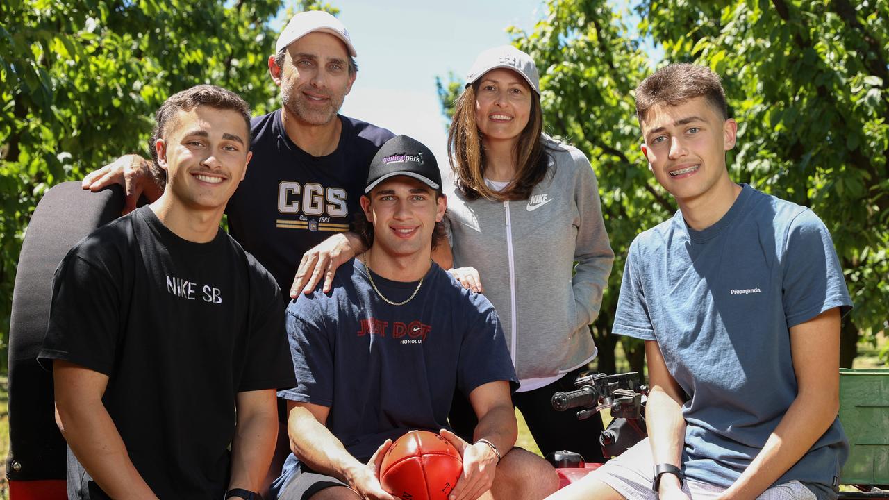 Josh Rachele with his family at their orchard outside of Shepparton. Picture: Michael Klein.