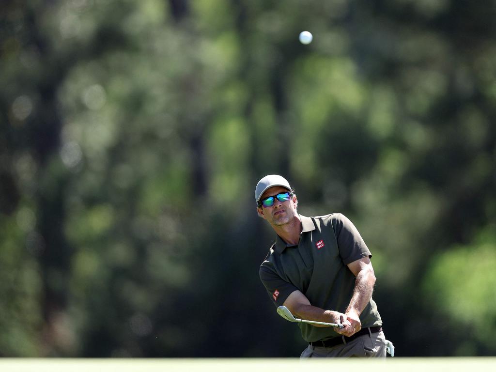 Adam Scott chips onto the 18th green. Picture: AFP