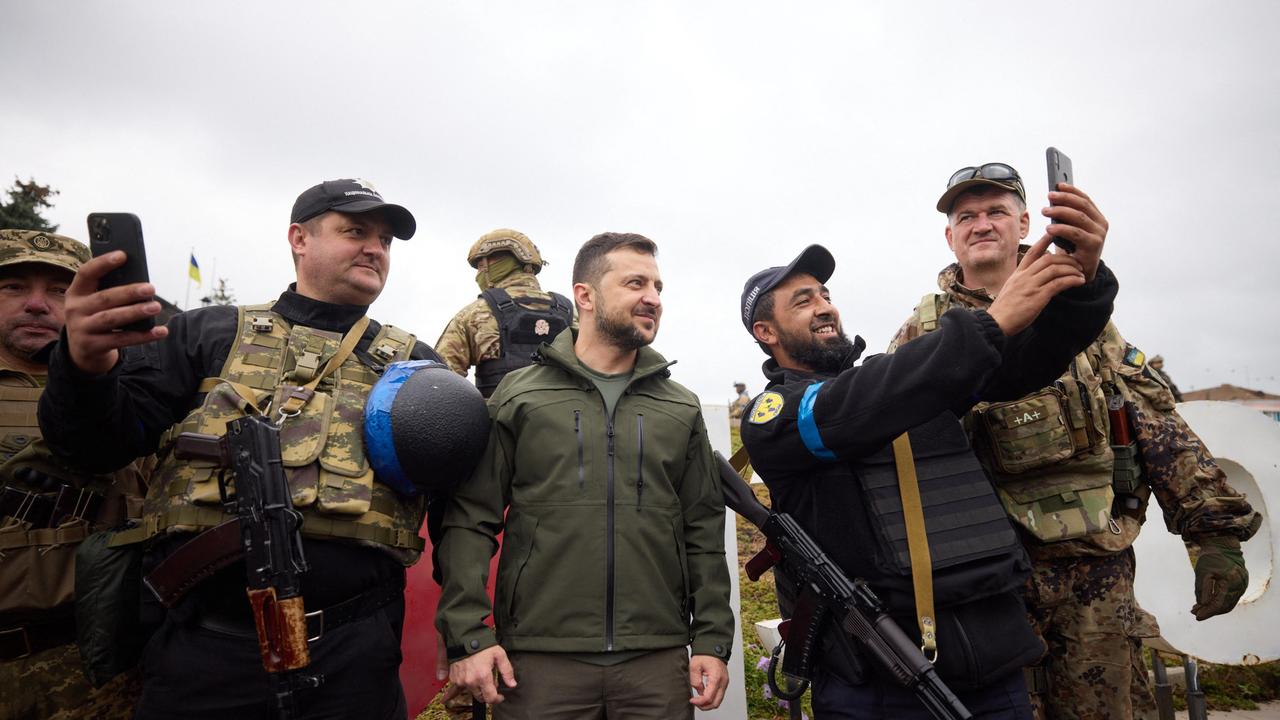 Ukrainian President Volodymyr Zelensky, centre, posing with servicemen in the de-occupied city of Izyum, Kharkiv region. Picture: AFP