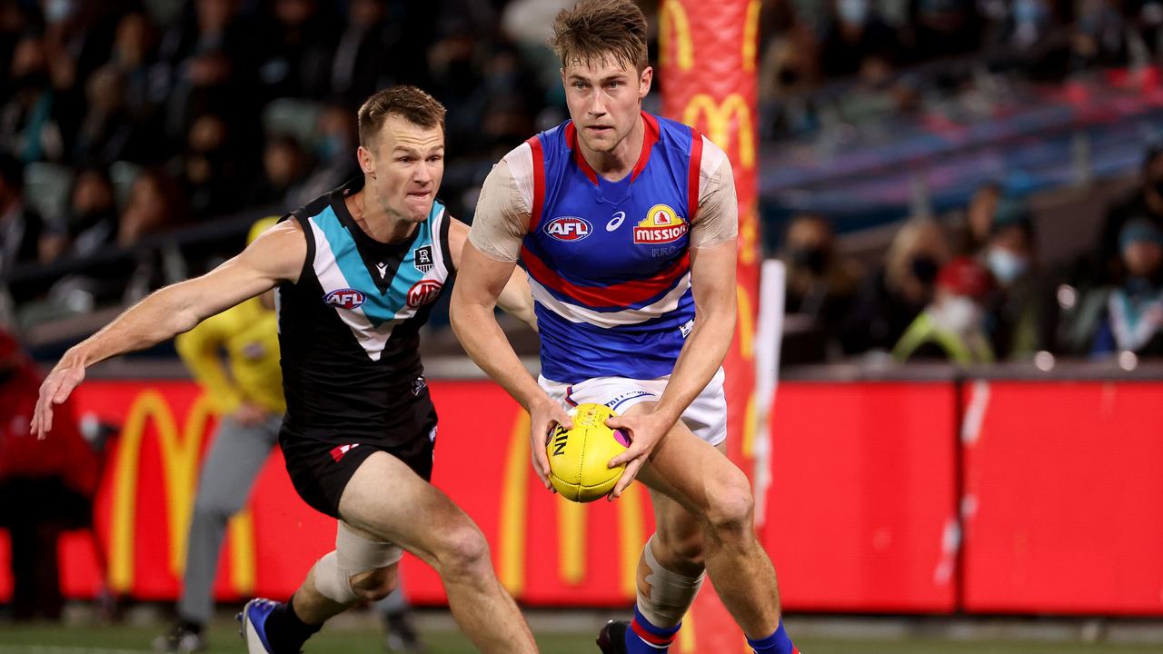 ADELAIDE, AUSTRALIA - SEPTEMBER 11: Ryan Gardner of the Bulldogs is tackled by Robbie Gray of the Power during the 2021 AFL Second Preliminary Final match between the Port Adelaide Power and the Western Bulldogs at Adelaide Oval on September 11, 2021 in Adelaide, Australia. (Photo by James Elsby/AFL Photos via Getty Images)