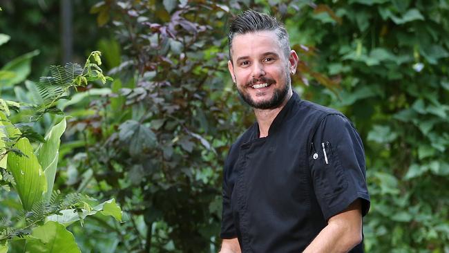 Executive chef at Silky Oaks Lodge Mark Godbeer picks some edible leaves in the chef's garden located on the grounds of the lodge. Picture: Brendan Radke